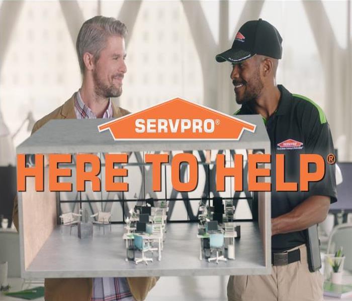 SERVPRO Logo with text, Here to Help, over image of client and technician holing a model of an office space